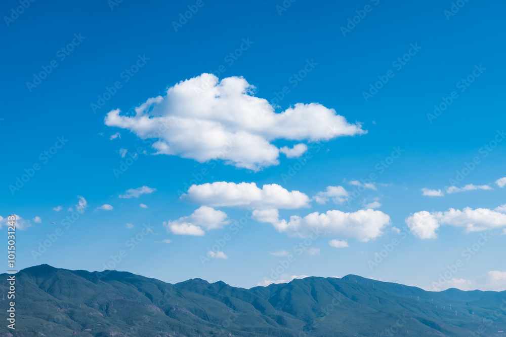The blue sky and white clouds over the mountains The blue sky and white clouds over the mountains