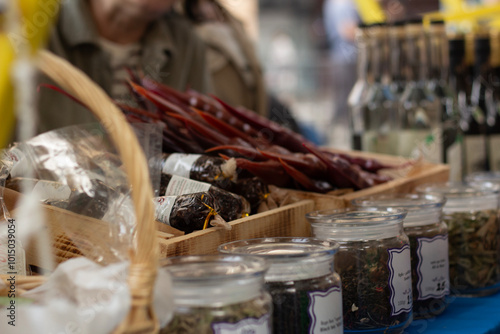 Stand in street shop. Farm counter. Table with spices in glass jars, alcohol, drink, bottle, adjika, churchkhela, basket. Autumn harvest festival Tbilisoba. Tbilisi. Georgia. City holiday fair. Cafe photo