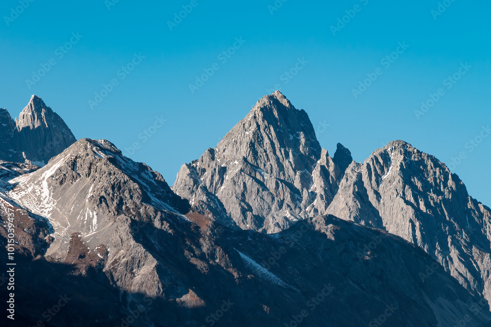 Snow-capped mountains under a clear blue sky Snow-capped mountains under a clear blue sky