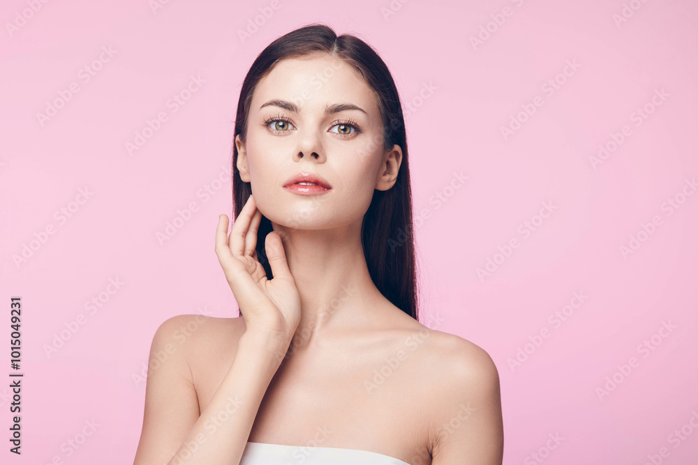 Young woman with hands on face posing on pink background, skincare and beauty concept Young woman with hands on face posing on pink background, skincare and beauty concept