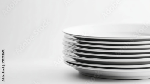 A minimalist view of a stack of pristine porcelain plates against a bright white background, emphasizing the simplicity and elegance of fine diningware