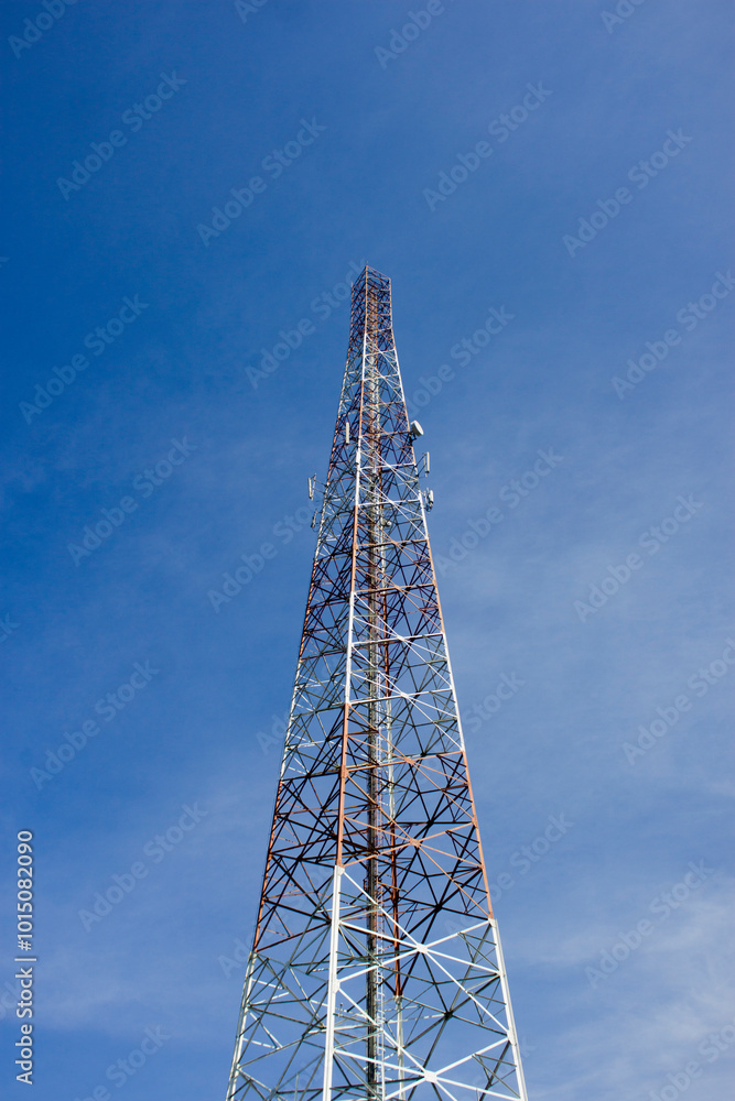 Provider transmitter mast on the side of the road with a view of the blue sky
Provider transmitter mast on the side of the road with a view of the blue sky