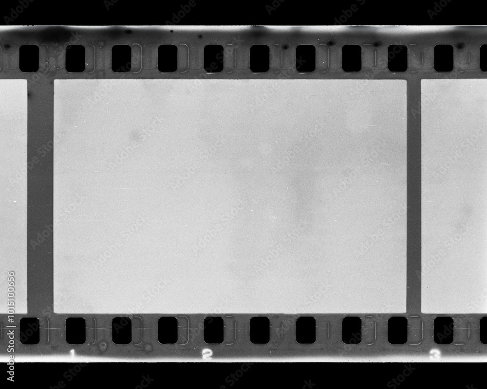 Stained and scratched old black and white 35mm film frame strip. Stained and scratched old black and white 35mm film frame strip.