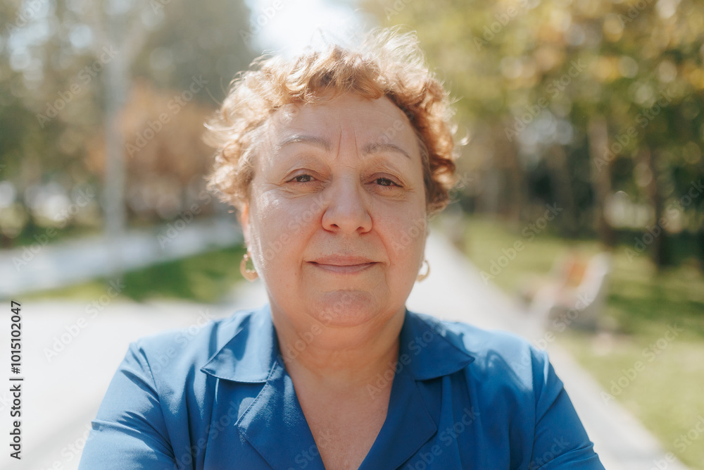 Elderly Woman Smiling at the Camera in an Outdoor Setting Elderly Woman Smiling at the Camera in an Outdoor Setting