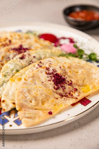 Delicious qutab being served on a plate with sumac spice photo