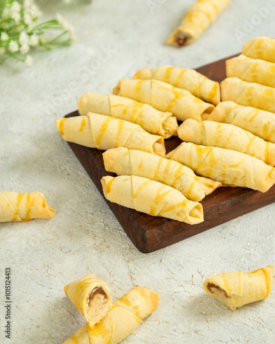 Freshly baked rugelach cookies lying on wooden board photo