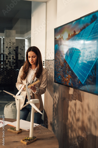 Innovative businesswoman representing sustainable ideology at boardroom photo