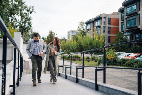 Business people walking and talking during coffee break in the city