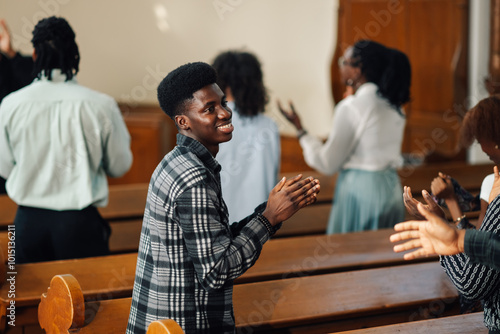Group of people clapping hands and singing gospel at church
