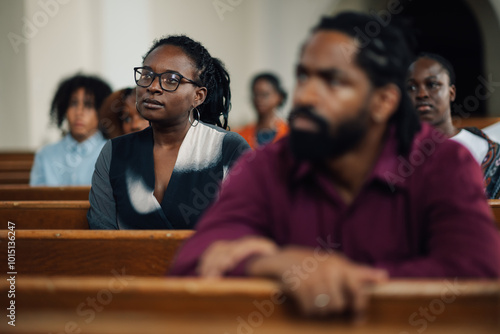 Fototapeta Group of churchgoers sitting in pews listening to sermon