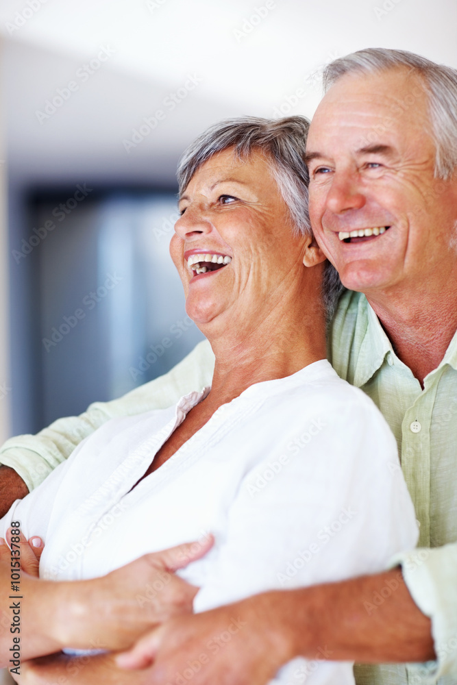 Obraz premium Elderly couple, laughing and hug in home for relax, bonding and love with support, care and romance. Senior people, funny and connection in house for weekend break, marriage and embrace with trust