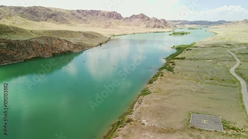 The flight over the Ile River is not far from Almaty. People ride supboards on the river. photo