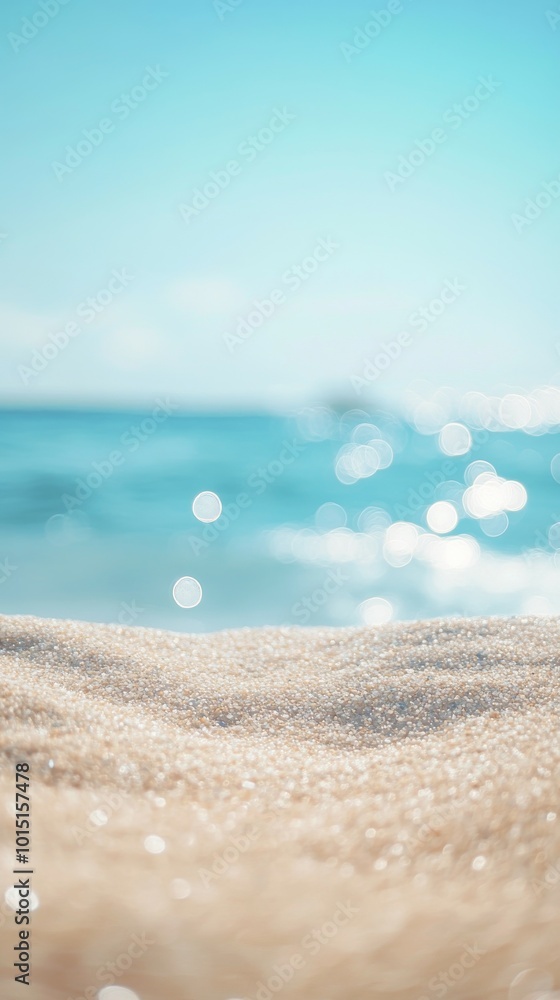 Soft light beach sand in the foreground and shimmering sea with sunrays in the background Soft light beach sand in the foreground and shimmering sea with sunrays in the background