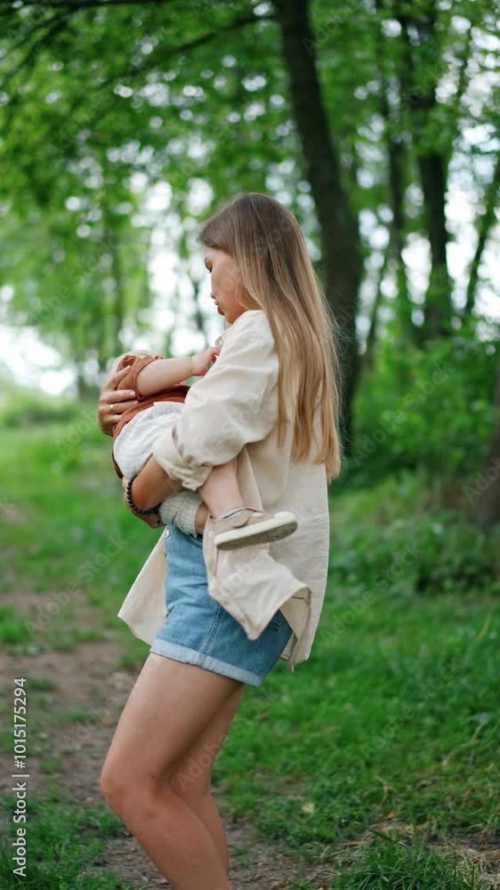 Happy mother waving her baby boy in hands standing in the nature. Mom and son spend time together outdoors in summer. Vertical video. Happy mother waving her baby boy in hands standing in the nature. Mom and son spend time together outdoors in summer. Vertical video.