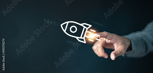 innovation, idea, startup, creative, future, learning, solution, strategy, vision, plan. A hand is pointing at a rocket on a black background. The rocket is drawn in white and he is in motion. photo