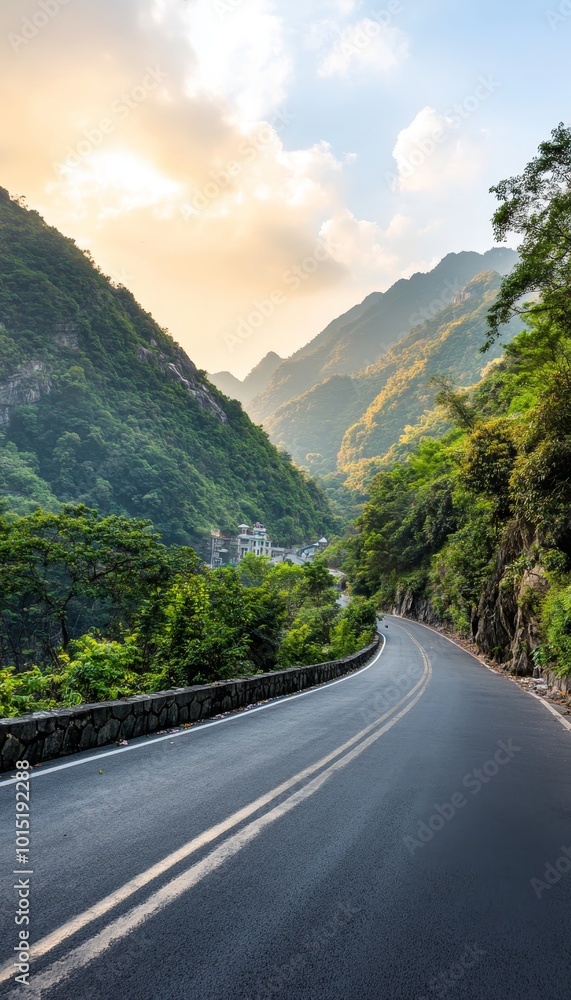 Fototapeta premium Winding Mountain Road at Sunset. Picturesque route with turns through lush rainforest.