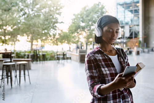 Konstfotografi Headphones, girl and student walking with phone for listening to radio, educational podcast and book