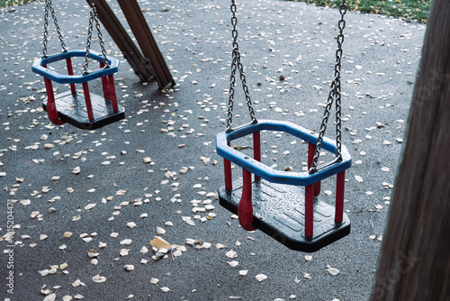 Two swings in the playground on a cloudy day