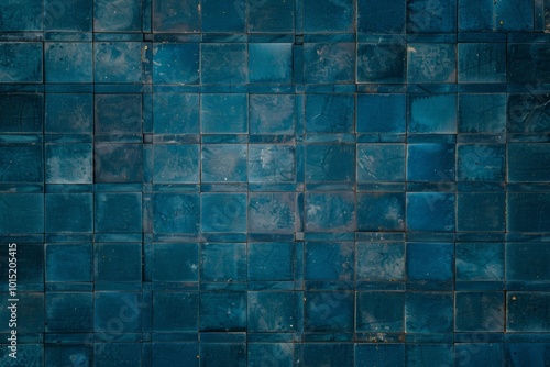 A close-up of a wall covered in deep blue square tiles.