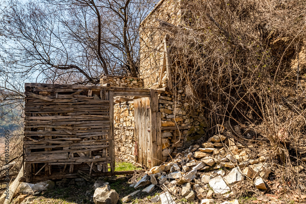 Abandoned houses and other buildings, lit by sunlight, street view, Pirin village and mountain, Bulgaria Abandoned houses and other buildings, lit by sunlight, street view, Pirin village and mountain, Bulgaria