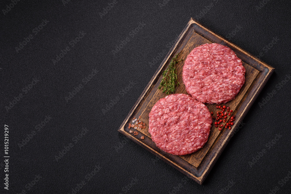 Fresh raw ground beef burger patty with salt and spices Fresh raw ground beef burger patty with salt and spices