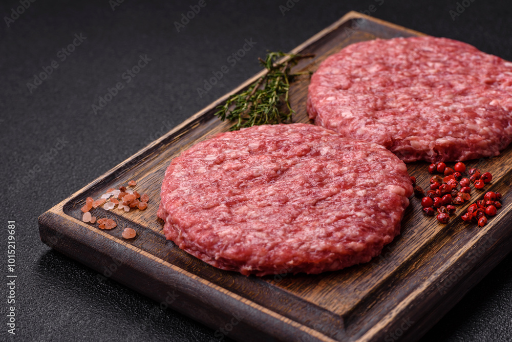 Fresh raw ground beef burger patty with salt and spices