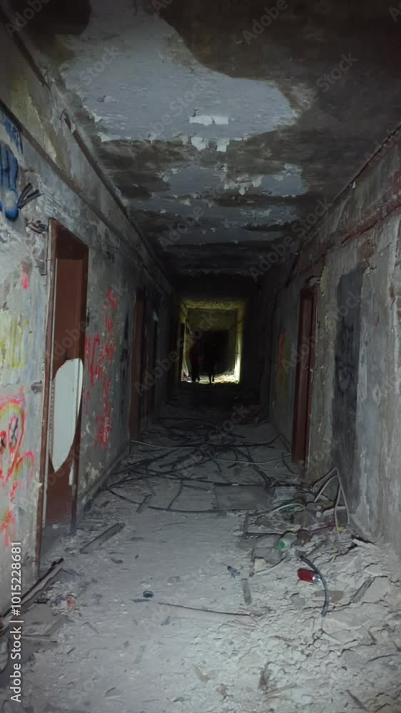 An abandoned old building with crumbling walls, illuminated by a streetlamp at night, missing windows and doors. Urban tourism An abandoned old building with crumbling walls, illuminated by a streetlamp at night, missing windows and doors. Urban tourism