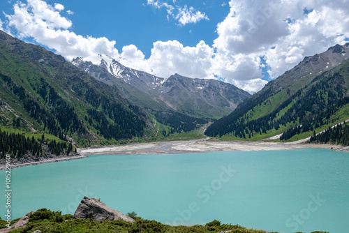 Panorama of Big Almaty Lake in the mountains in summer. Beautiful high-mountain lake not far from Almaty. photo