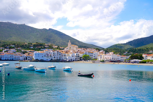 view over the Badia de Cadaqués, to the beautiful white houses of Cadaqués, Port Alguer and the turquoise water of the Mediterranean Sea, mountains of the Pyrenees behind, Girona, Catalonia, Spain