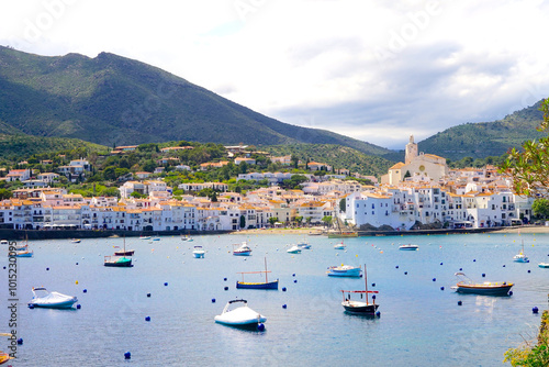 view over the Badia de Cadaqués, to the beautiful white houses of Cadaqués, Port Alguer and the turquoise water of the Mediterranean Sea, mountains of the Pyrenees behind, Girona, Catalonia, Spain photo