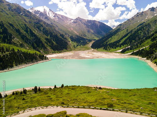 Panorama of Big Almaty Lake in the mountains in summer. Beautiful high-mountain lake not far from Almaty. photo