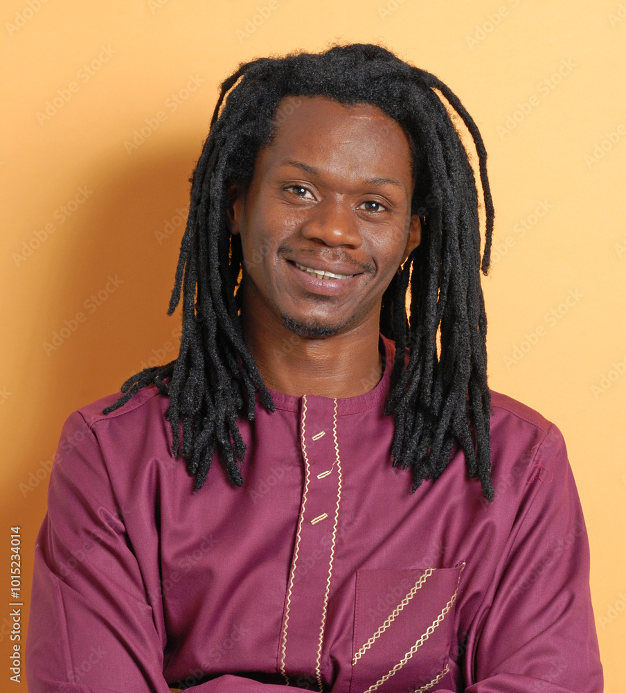 African curly hair man portrait on orange background. African curly hair man portrait on orange background.
