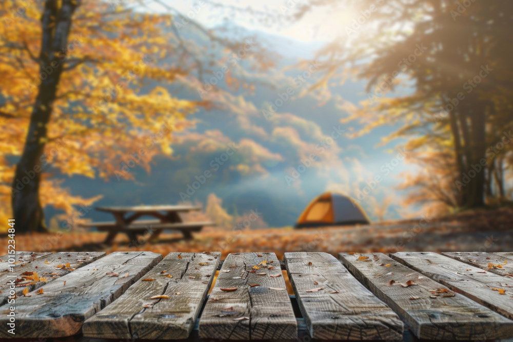Wooden table with free space for decorating. Blurred autumn mountain camping background, morning light. Wooden table with free space for decorating. Blurred autumn mountain camping background, morning light.