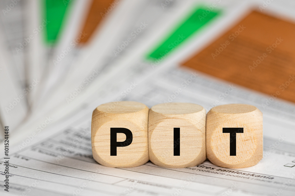 Annual tax settlement in Poland, Form for private persons, Wooden blocks with the word PIT (Personal Income Tax)