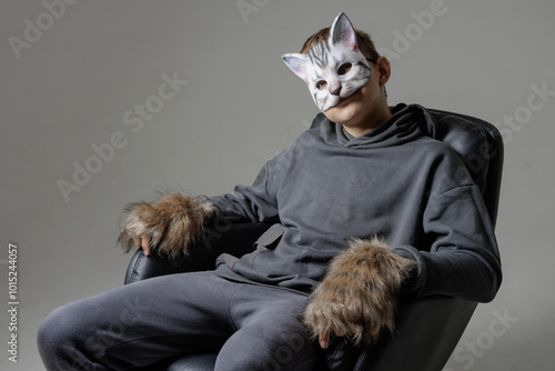 portrait of a teenager quadrobics in a cat mask on a white background, quadrobika subculture photo