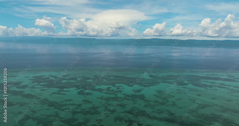 Aerial drone of the island of Cebu from the sea. Blue ocean and sky with clouds. Seascape in the tropics. Aerial drone of the island of Cebu from the sea. Blue ocean and sky with clouds. Seascape in the tropics.