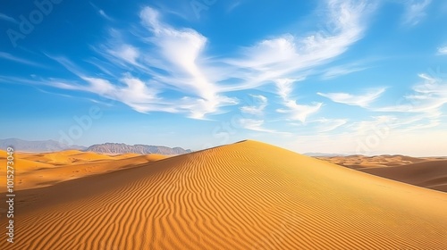 A peaceful desert scene featuring golden sand dunes beneath a clear blue sky with wispy clouds. The untouched sand patterns and bright horizon evoke feelings of calm and isolation, ideal for travel