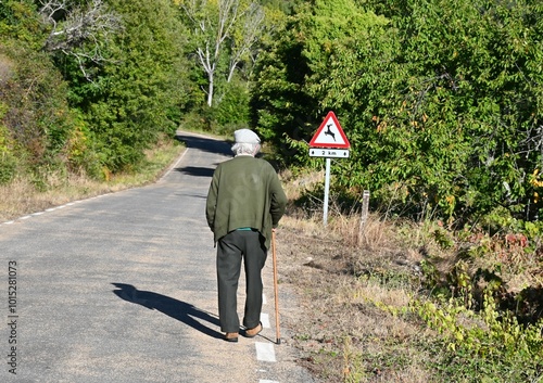 abuelo paseando en un pueblo de salamanca, españa photo