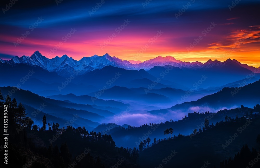 Obraz premium At dawn, vivid colors paint the sky as sunlight begins to rise over the mountain range, casting a tranquil glow on the valleys