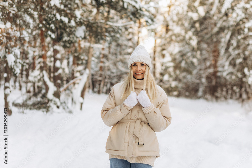 Winter portrait young beautiful woman with blond hair dressed in warm clothes with a knitted hat, smiling Winter portrait young beautiful woman with blond hair dressed in warm clothes with a knitted hat, smiling
