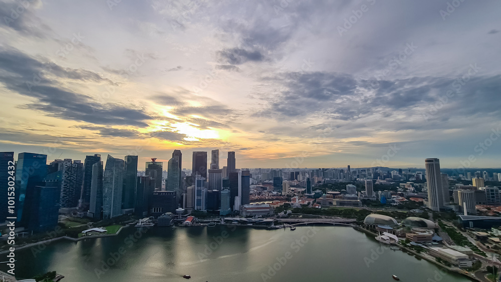 custom made wallpaper toronto digitalScenic aerial view of Singapore iconic skyline at dusk. Towering skyscrapers, illuminated by setting sun. Marina Bay waterfront with its bustling activity and vibrant lights. SkyPark Observation Deck