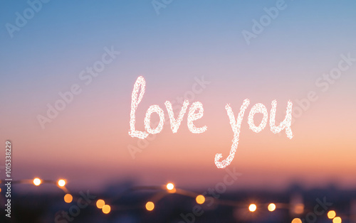 Handwritten 'Love You' glowing softly with romantic bokeh lights and candles set against a dreamy evening sky photo