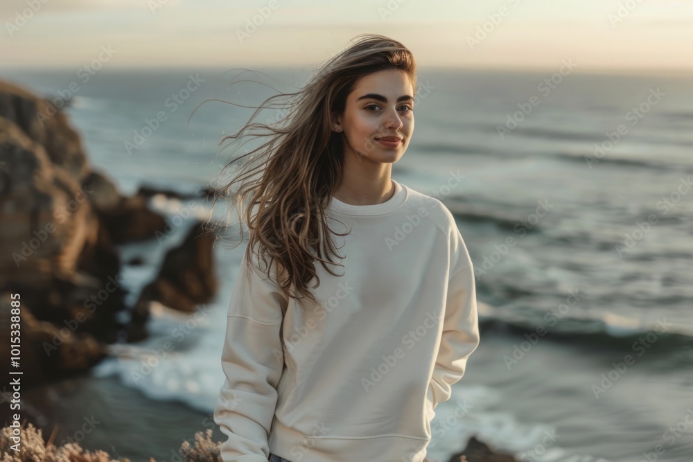 Young woman in a white sweatshirt by the ocean at sunset. Casual fashion and seaside lifestyle concept. Mockup. Generative AI Young woman in a white sweatshirt by the ocean at sunset. Casual fashion and seaside lifestyle concept. Mockup. Generative AI