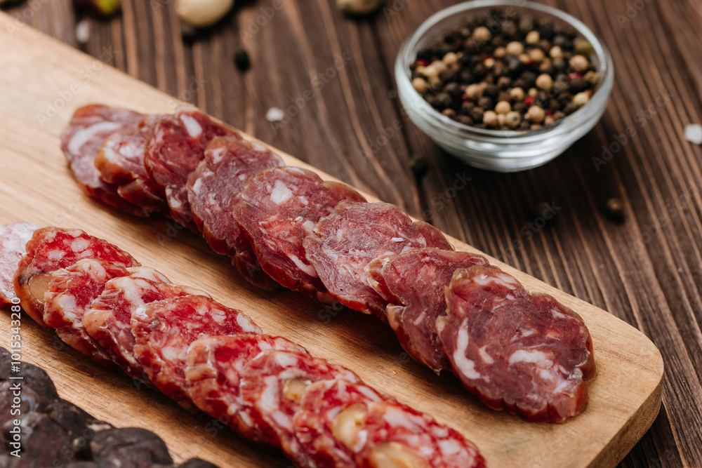 Close-up of sliced salami with nuts, gourmet meat textures and flavors, charcuterie boards Close-up of sliced salami with nuts, gourmet meat textures and flavors, charcuterie boards