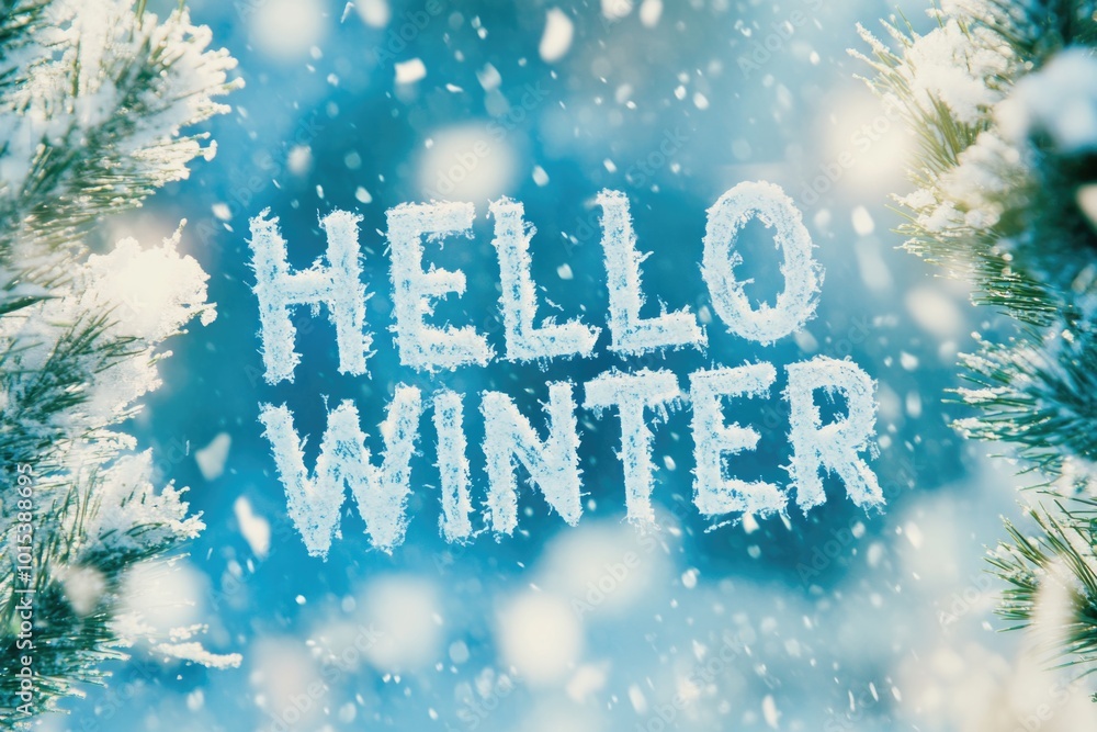 Hello winter: snowy pines and festive seasonal greeting amid falling snow Hello winter: snowy pines and festive seasonal greeting amid falling snow