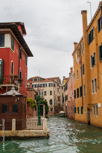 Wallpaper Mural Colorful Venetian Canal Scene with Historic Buildings and Calm Waters.
A serene Venetian canal lined with colorful historic buildings, featuring calm water and a cloudy sky. Torontodigital.ca