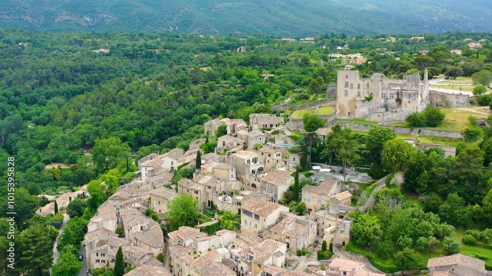 View of the old town of Lacoste, ancient village in France, Vaucluse, Provence-Alpes-Cote d'Azur, Park of Luberon. Lacoste village picturesque countryside of France surrounded by lush green hills.