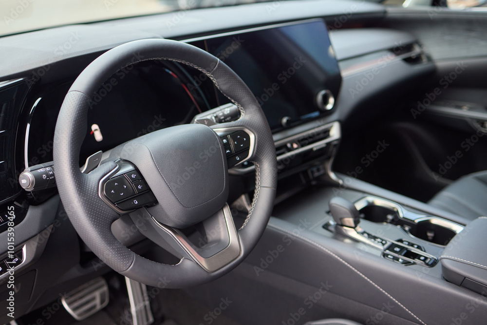 Closeup of a modern car steering wheel with control buttons for technology and convenience Closeup of a modern car steering wheel with control buttons for technology and convenience
