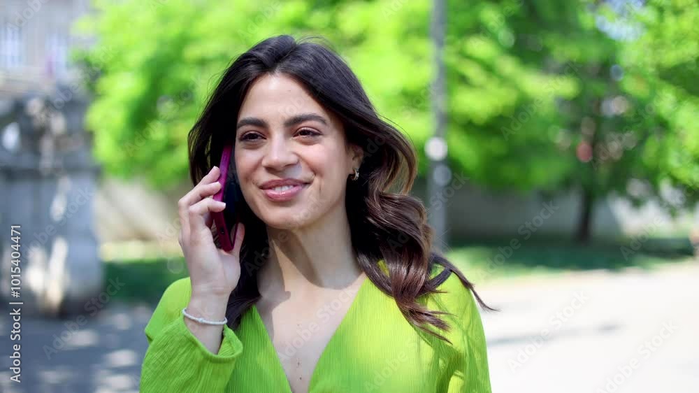 Beautiful Mexican woman telephoning outdoors Beautiful Mexican woman telephoning outdoors