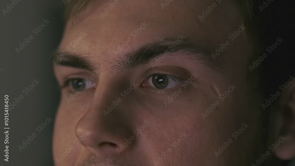 Obraz premium Man looks at computer screen and wins. Clip. Man successfully created the code or won computer game. Gamer or programmer is happy looking at computer screen